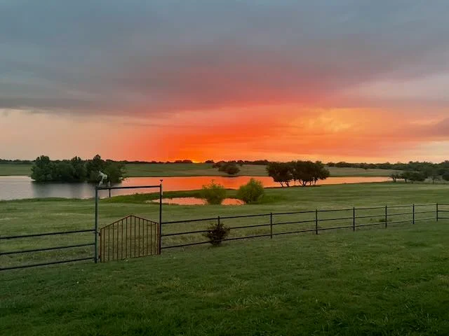 Spectacular sunset over EC Ranch lake with vibrant orange and pink reflections